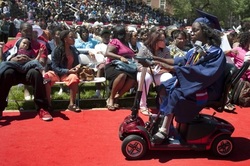 Photo from Washington Post of Britney Wilson using electric wheelchair at graduation, rolling up a red carpet